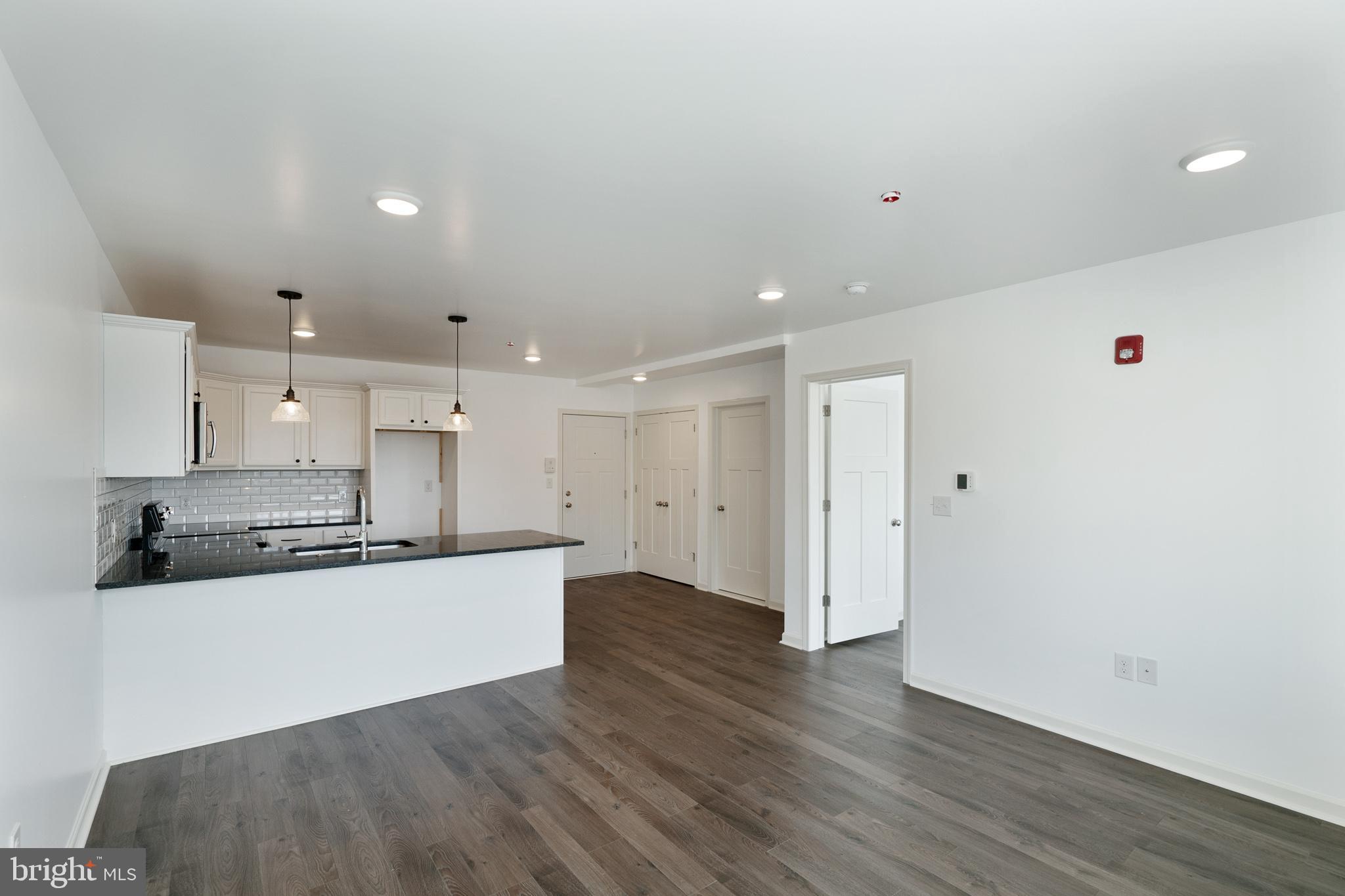 5420 Ridge Avenue, Unit 206 Philadelphia, PA 19128 - Photo 5 of 10 a kitchen with stainless steel appliances a refrigerator and a stove top oven