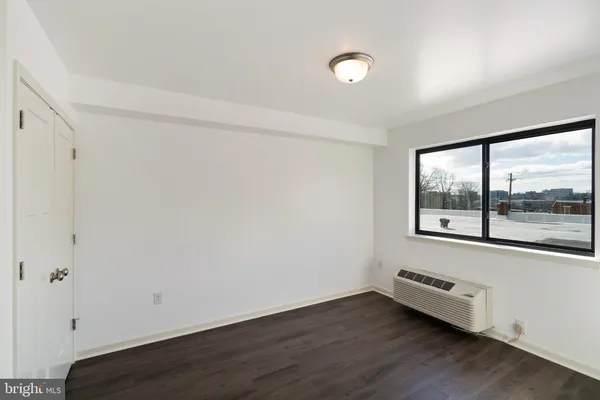 a view of a room with wooden floor and window