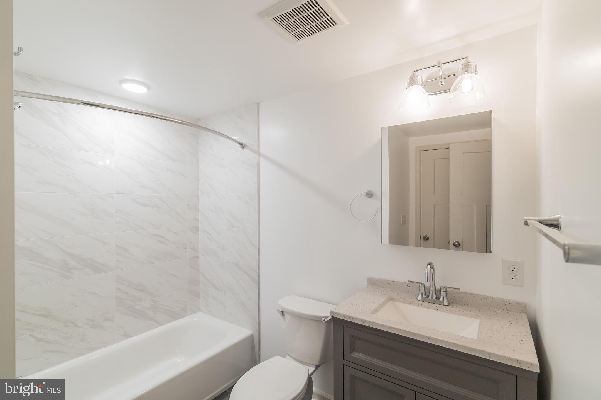 5420 Ridge Avenue, Unit 206 Philadelphia, PA 19128 - Photo 9 of 10 a bathroom with a sink toilet and shower