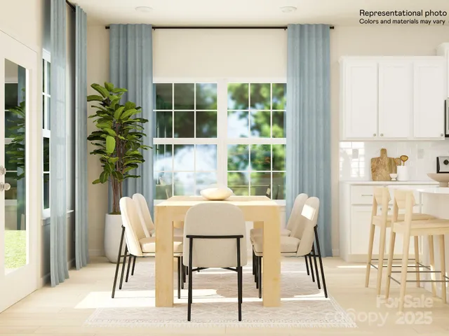 a dining room with furniture and a kitchen view