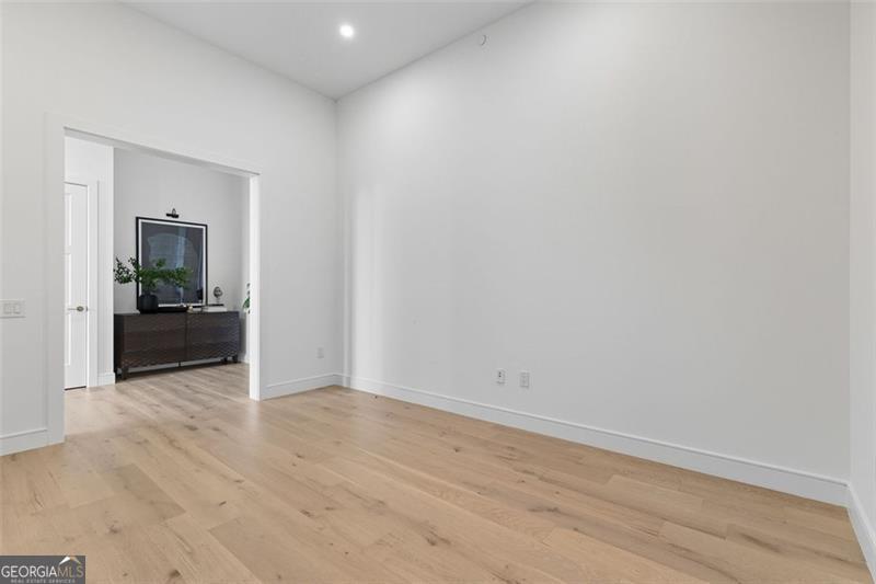 2425 Peachtree Road, Unit 1504 Atlanta, GA 30305 - Photo 14 of 66 a view of an empty room with wooden floor and a bench