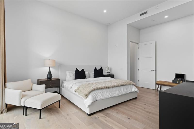 2425 Peachtree Road, Unit 1504 Atlanta, GA 30305 - Photo 18 of 66 a bedroom with a bed and a couch