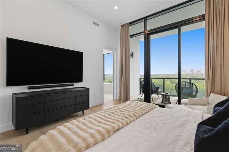 2425 Peachtree Road, Unit 1504 Atlanta, GA 30305 - Photo 19 of 66 a bedroom with a large bed and a flat screen tv