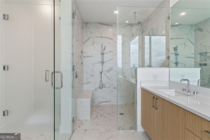 2425 Peachtree Road, Unit 1504 Atlanta, GA 30305 - Photo 22 of 66 a bathroom with a shower sink and mirror