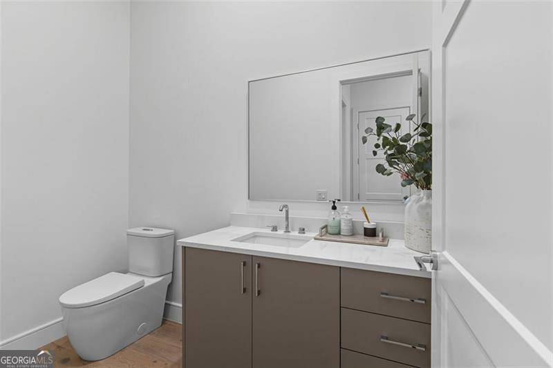 2425 Peachtree Road, Unit 1504 Atlanta, GA 30305 - Photo 25 of 66 a bathroom with a toilet sink and mirror