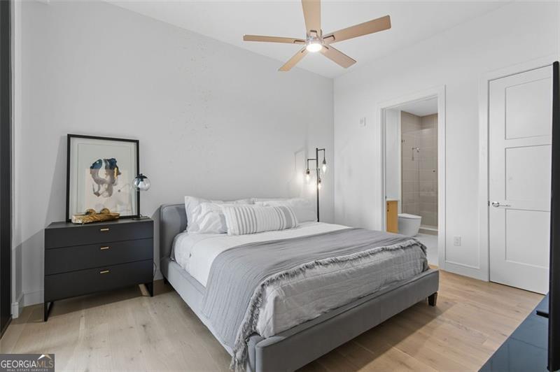 2425 Peachtree Road, Unit 1504 Atlanta, GA 30305 - Photo 27 of 66 a bedroom with a bed and a painting on the wall