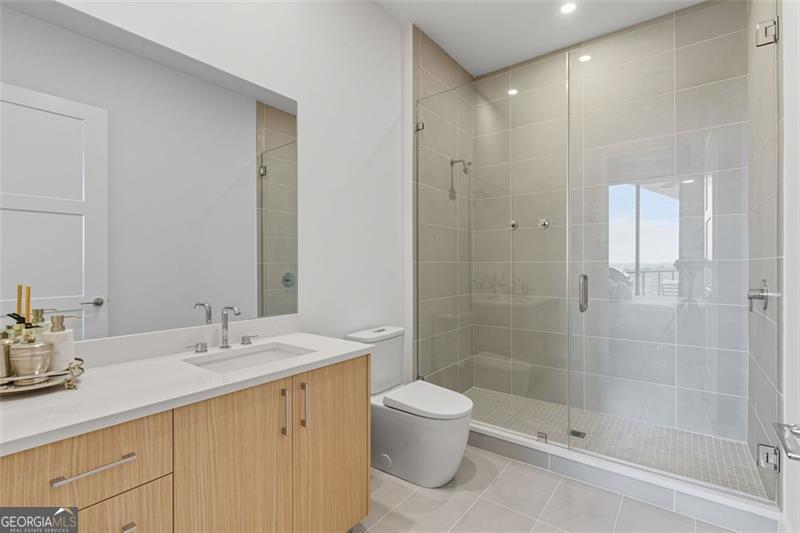 2425 Peachtree Road, Unit 1504 Atlanta, GA 30305 - Photo 28 of 66 a bathroom with a shower sink and toilet