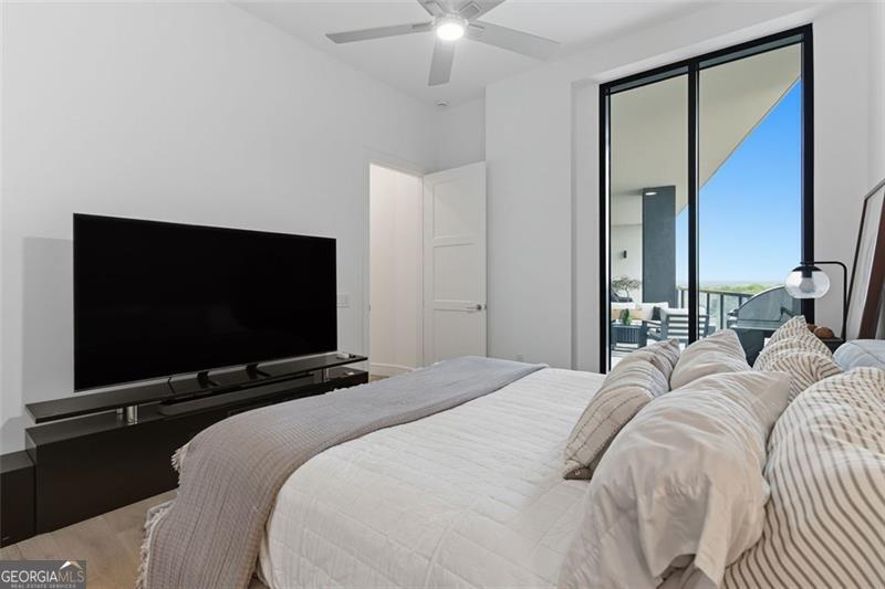 2425 Peachtree Road, Unit 1504 Atlanta, GA 30305 - Photo 29 of 66 a bedroom with a bed and a flat screen tv