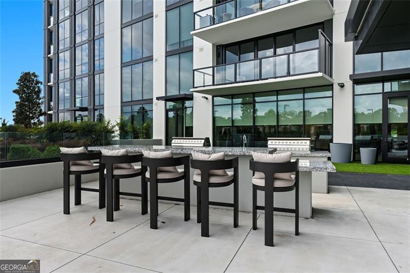 2425 Peachtree Road, Unit 1504 Atlanta, GA 30305 - Photo 40 of 66 a view of a patio with a table and chairs and potted plants