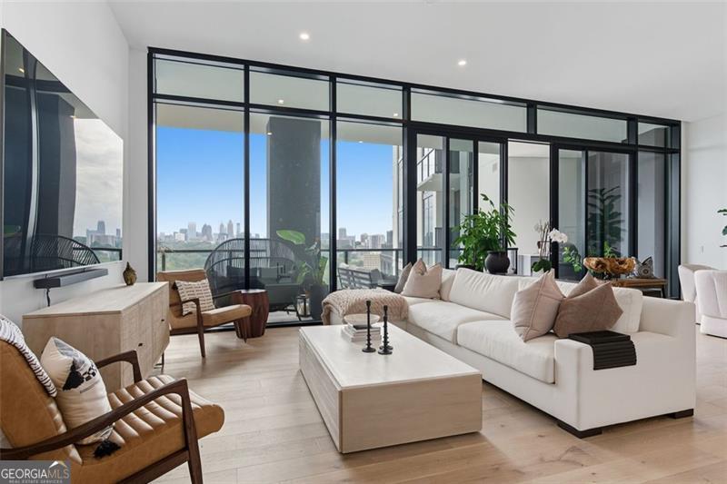 2425 Peachtree Road, Unit 1504 Atlanta, GA 30305 - Photo 4 of 66 a living room with furniture and large windows
