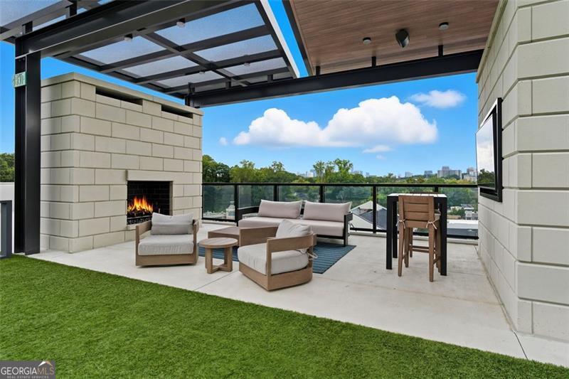 2425 Peachtree Road, Unit 1504 Atlanta, GA 30305 - Photo 44 of 66 a view of a porch with furniture and a yard