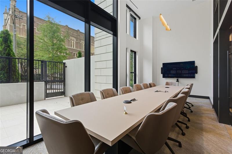 2425 Peachtree Road, Unit 1504 Atlanta, GA 30305 - Photo 53 of 66 a living room with a table and a flat screen tv