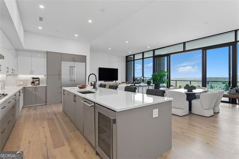 2425 Peachtree Road, Unit 1504 Atlanta, GA 30305 - Photo 6 of 66 a large white kitchen with a large window and stainless steel appliances