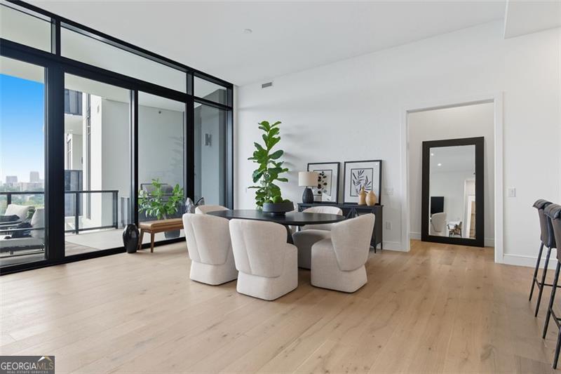2425 Peachtree Road, Unit 1504 Atlanta, GA 30305 - Photo 8 of 66 a living room with a couch and a large window