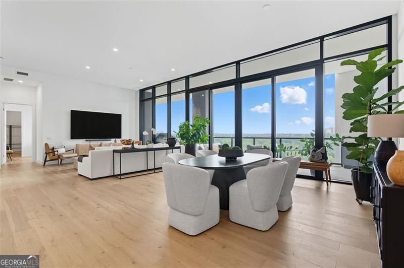 2425 Peachtree Road, Unit 1504 Atlanta, GA 30305 - Photo 10 of 66 a living room with furniture tv and a large window