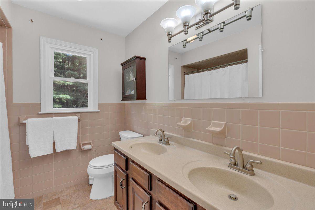 298 North Post Road Princeton Junction, NJ 08550 - Photo 24 of 35 a bathroom with a sink a toilet and a mirror