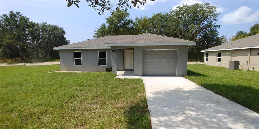 a front view of a house with yard
