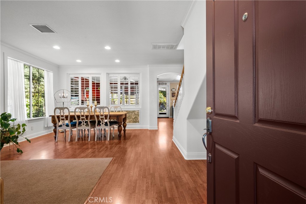 26214 Reade Place Stevenson Ranch, CA 91381 - Photo 11 of 58 a view of a dining room with furniture window and wooden floor