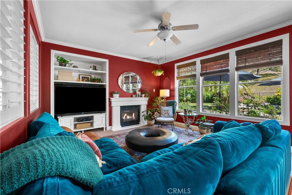 26214 Reade Place Stevenson Ranch, CA 91381 - Photo 15 of 58 a living room with furniture a fireplace and a flat screen tv