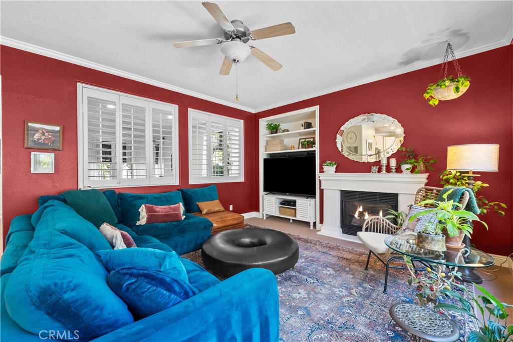 26214 Reade Place Stevenson Ranch, CA 91381 - Photo 16 of 58 a living room with furniture a fireplace and a flat screen tv