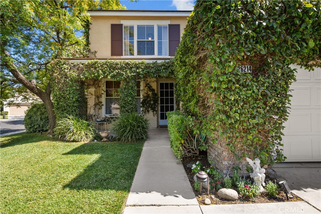 26214 Reade Place Stevenson Ranch, CA 91381 - Photo 2 of 58 a front view of a house with garden