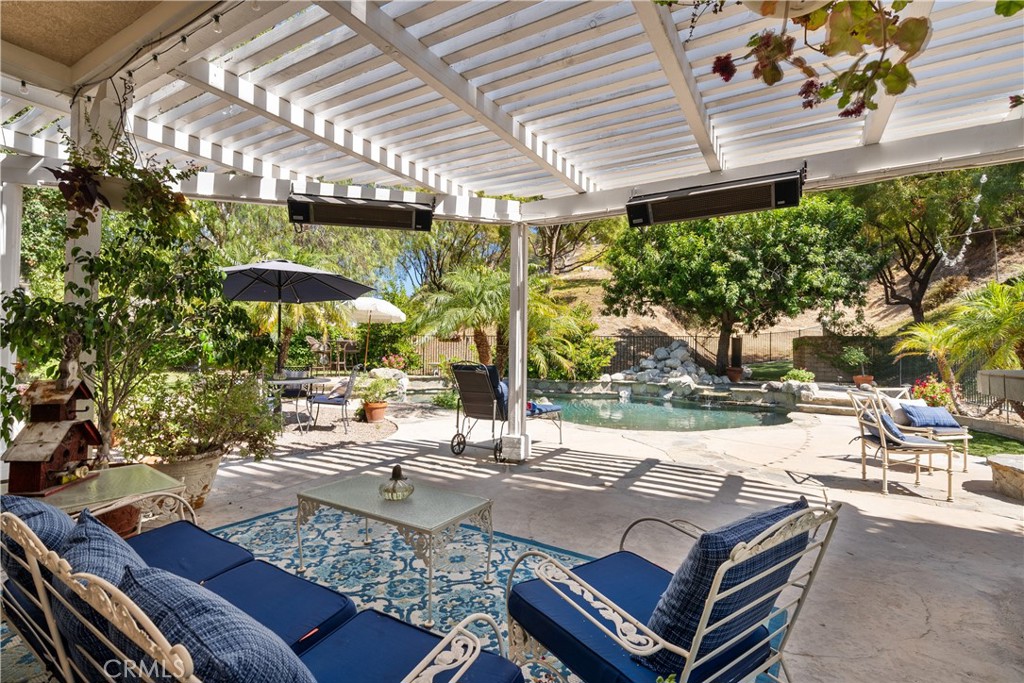 26214 Reade Place Stevenson Ranch, CA 91381 - Photo 22 of 58 a view of a patio with table and chairs and potted plants