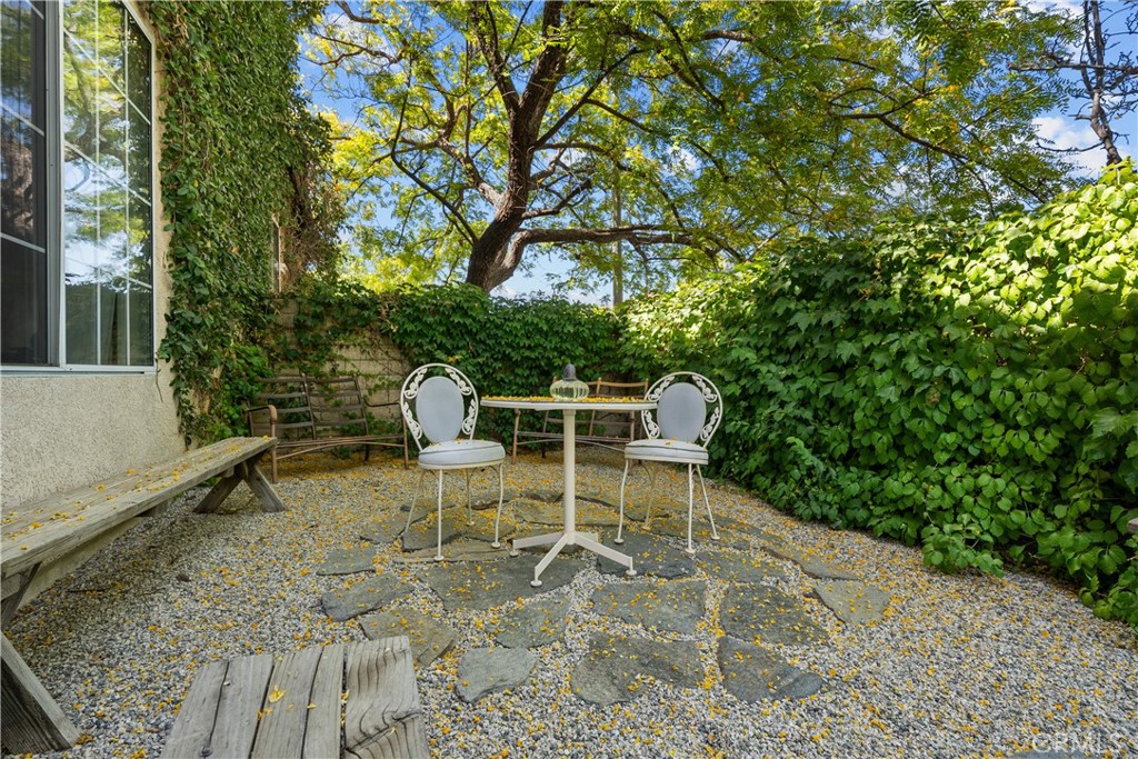 26214 Reade Place Stevenson Ranch, CA 91381 - Photo 31 of 58 a chair and table sitting in backyard with plants