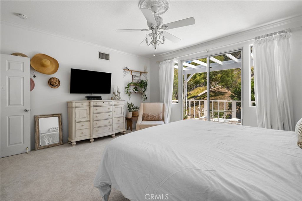 26214 Reade Place Stevenson Ranch, CA 91381 - Photo 33 of 58 a bedroom with a bed and a flat tv screen on dresser