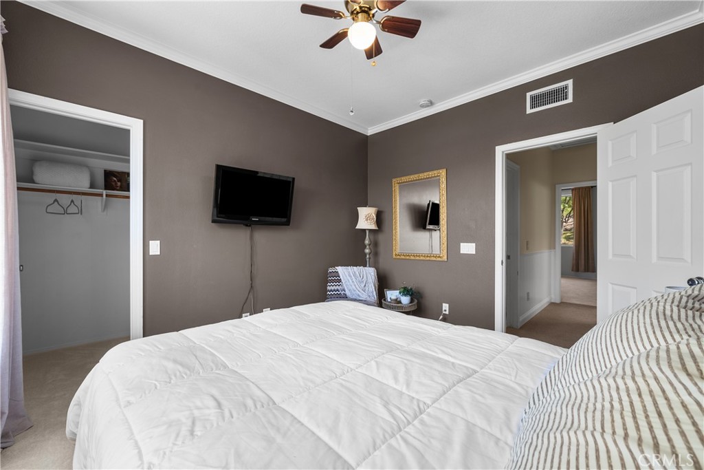 26214 Reade Place Stevenson Ranch, CA 91381 - Photo 38 of 58 a bedroom with a large bed and a flat tv screen on dresser
