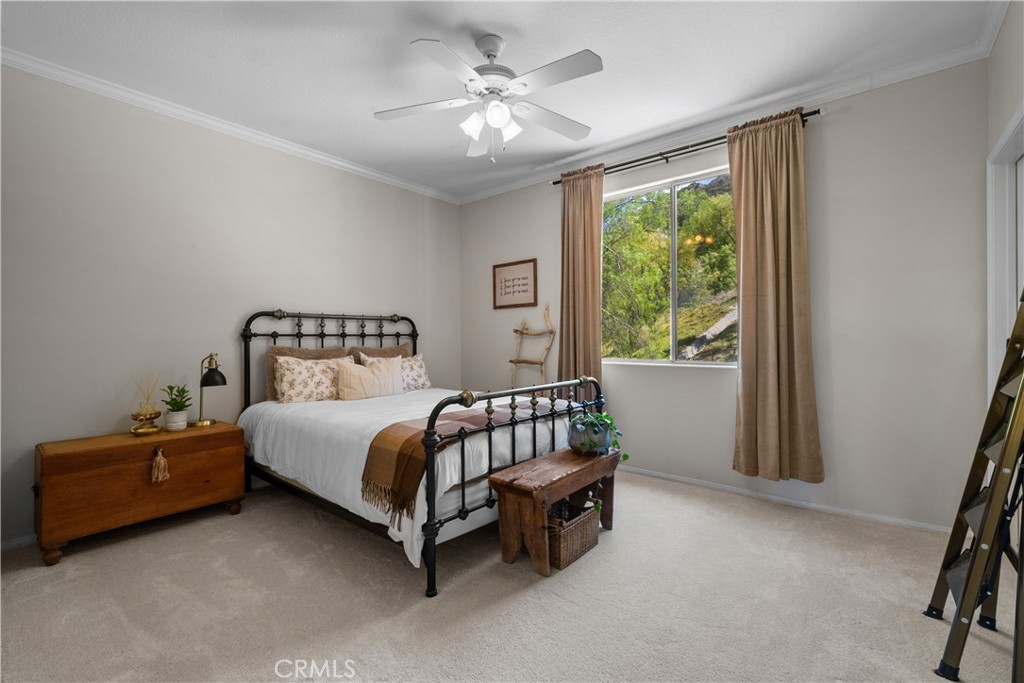 26214 Reade Place Stevenson Ranch, CA 91381 - Photo 41 of 58 a bedroom with a bed and a chandelier