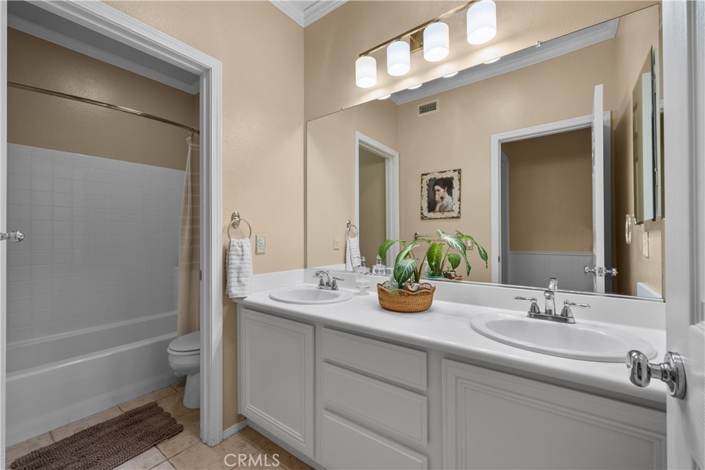 26214 Reade Place Stevenson Ranch, CA 91381 - Photo 43 of 58 a bathroom with a double vanity sink and a mirror