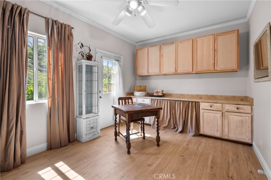 26214 Reade Place Stevenson Ranch, CA 91381 - Photo 47 of 58 a kitchen with cabinets table and chairs
