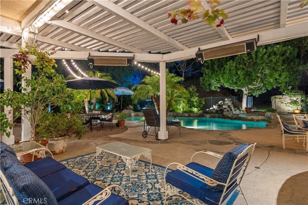 26214 Reade Place Stevenson Ranch, CA 91381 - Photo 51 of 58 a patio with a table and chairs under an umbrella