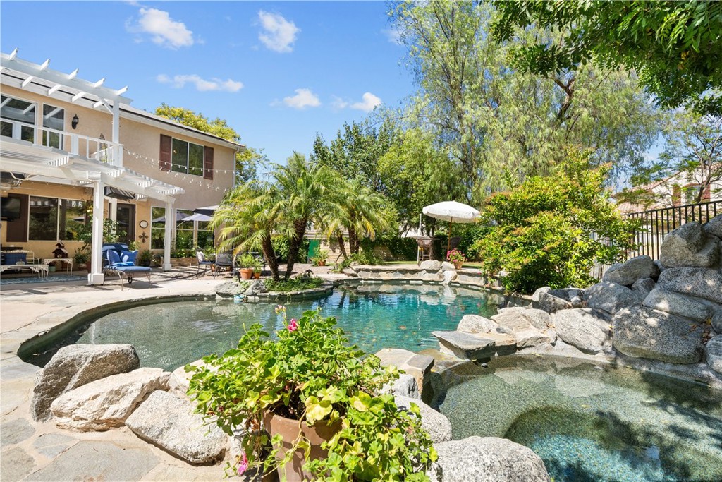 26214 Reade Place Stevenson Ranch, CA 91381 - Photo 7 of 58 a view of a swimming pool with a lounge chairs