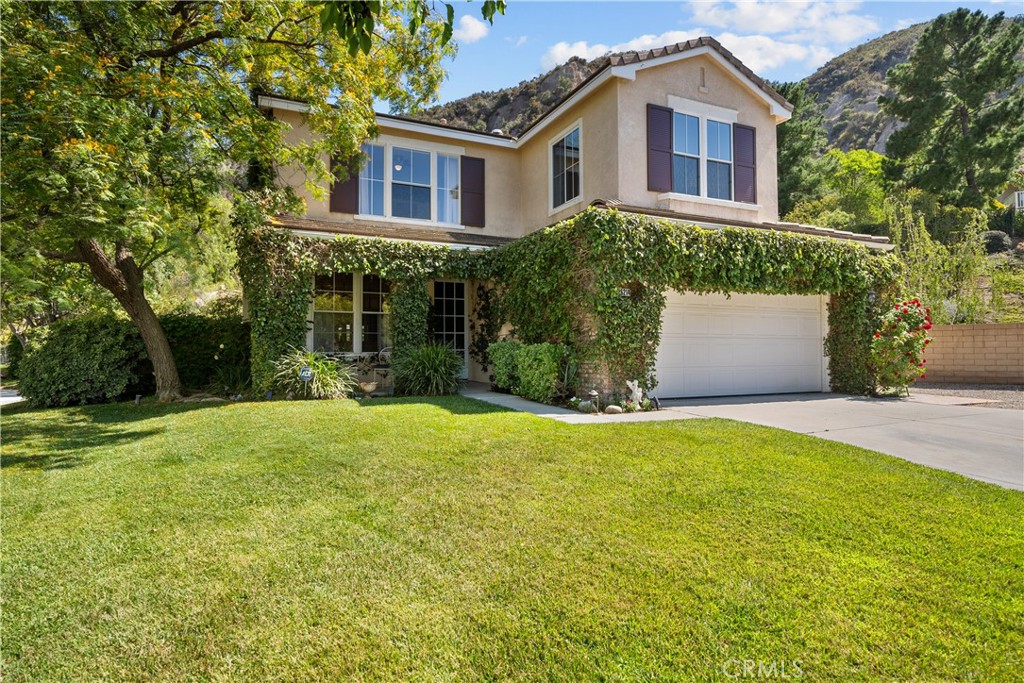 26214 Reade Place Stevenson Ranch, CA 91381 - Photo 10 of 58 a front view of house with yard and green space