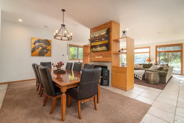 a dining room with furniture a chandelier and window
