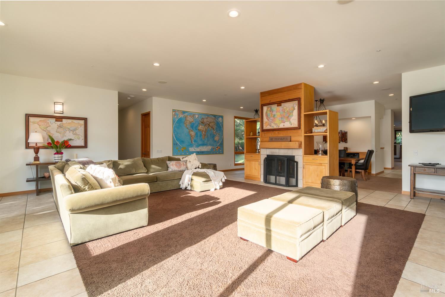 8 Circle Road San Rafael, CA 94903 - Photo 17 of 51 a living room with furniture a flat screen tv and a fireplace