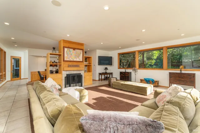 a living room with furniture large window and a fireplace