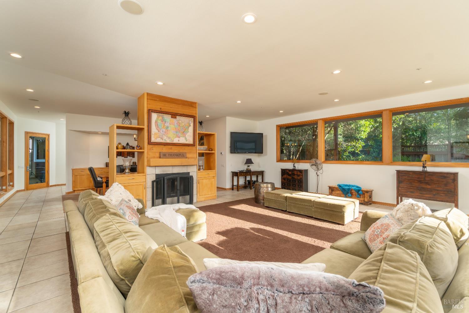 8 Circle Road San Rafael, CA 94903 - Photo 18 of 51 a living room with furniture large window and a fireplace