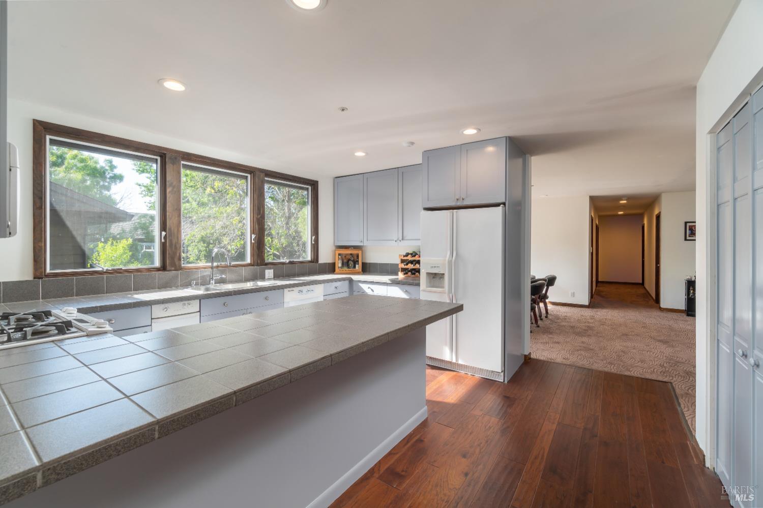 8 Circle Road San Rafael, CA 94903 - Photo 19 of 51 a large kitchen with kitchen island a large counter space a sink appliances and a large window
