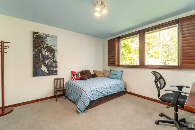 a bedroom with a bed and a table in it