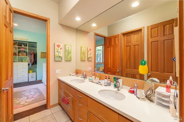 a bathroom with a double vanity sink and a mirror