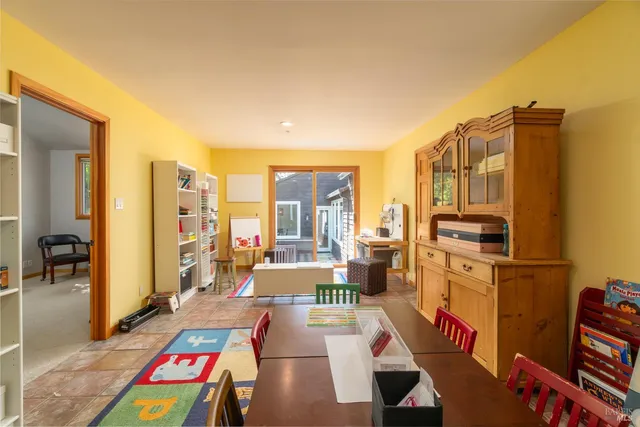 a view of hallway with wooden floor and cabinet