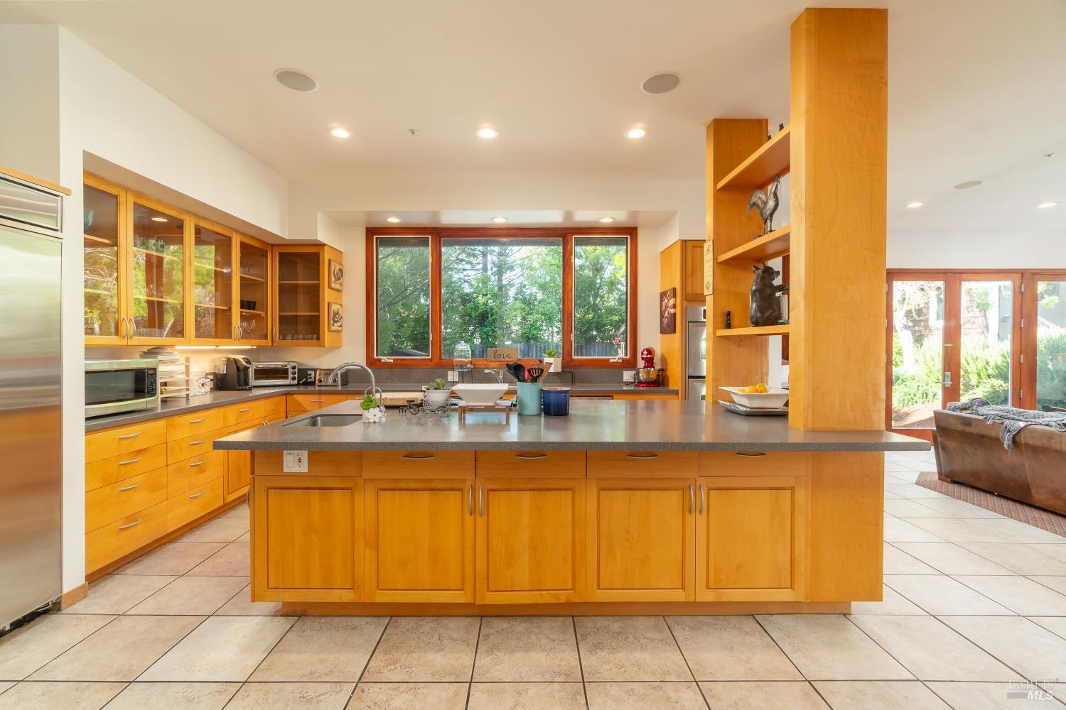8 Circle Road San Rafael, CA 94903 - Photo 8 of 51 a view of a kitchen with kitchen island granite countertop a large window cabinets and stainless steel appliances