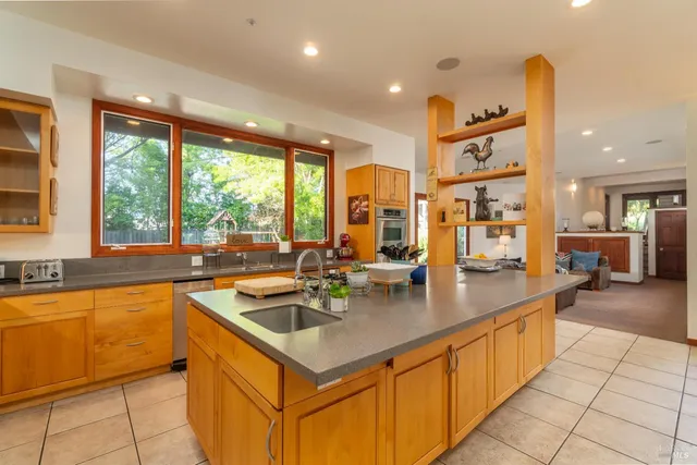 a kitchen with stainless steel appliances granite countertop a sink and a counter top space