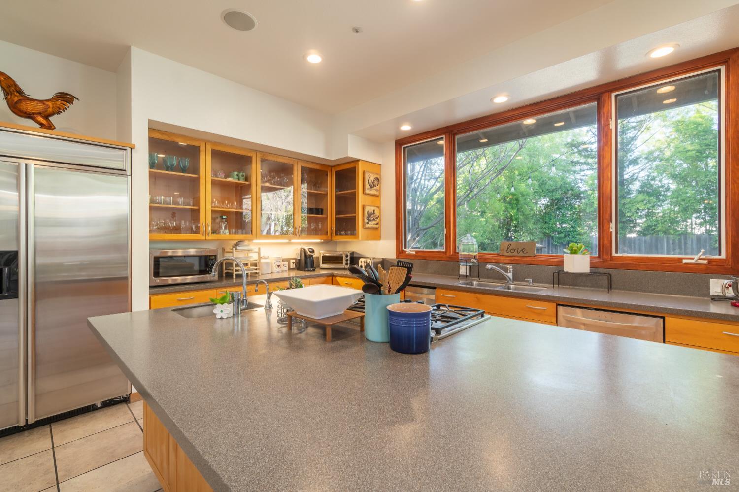 8 Circle Road San Rafael, CA 94903 - Photo 10 of 51 a dining room with stainless steel appliances granite countertop a refrigerator a sink a dining table and chairs