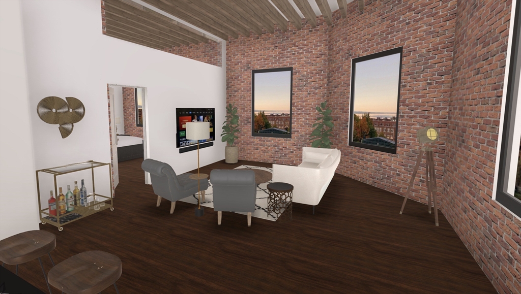 9 Central Street, Unit 602 Lowell, MA 01852 - Photo 2 of 14 a living room with furniture and a wooden floor