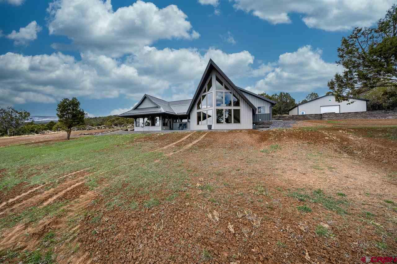 20885 Mesawood Road Cedaredge, CO 81413 - Photo 1 of 35 a view of a house with a yard