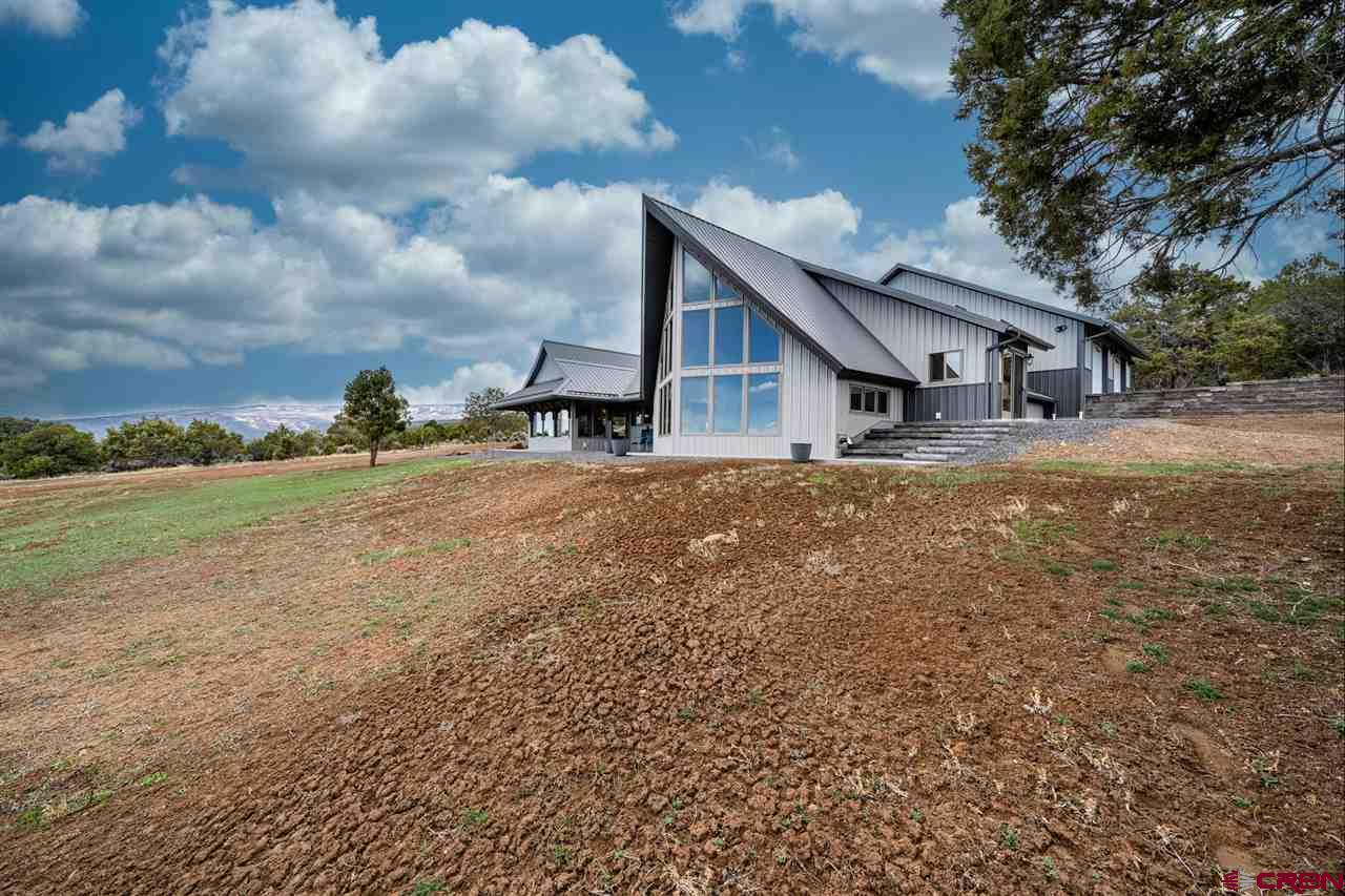 20885 Mesawood Road Cedaredge, CO 81413 - Photo 2 of 35 a view of a house with a yard
