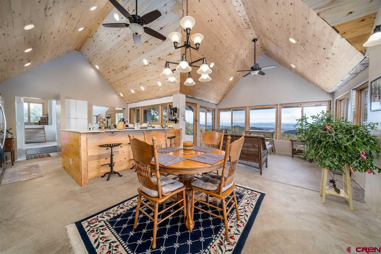 20885 Mesawood Road Cedaredge, CO 81413 - Photo 14 of 35 a view of a dining room with furniture and a chandelier